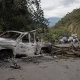 Ciudadanos observan operativo policial tras jornada de violencia en una calle urbana de Colombia.