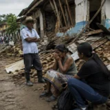 Familia afectada por terremoto observa daños en vivienda rural colombiana